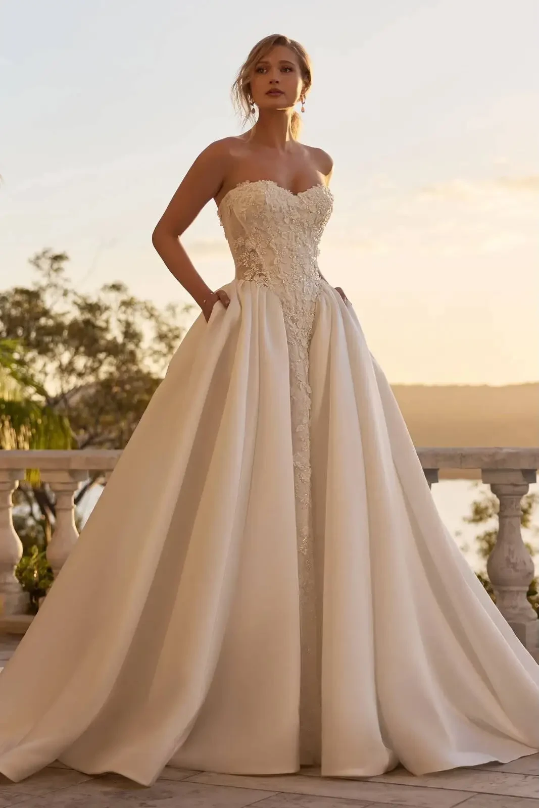 Model wearing a gown by Sophia Tolli