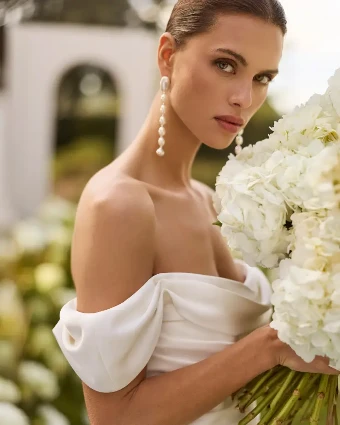 Nahe By Rosa Clará Wedding Gowns Price Range: $2999.99 - $7750.00 $1 Natural thumbnail